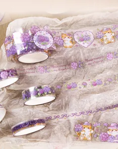 Close-up of decorative washi tape with cute cat and hydrangea motifs for DIY scrapbooking