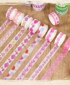 Detailed view of various pink washi tape rolls with floral and cute cartoon patterns.