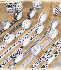 Close-up of various black and white patterned washi tape rolls for journaling