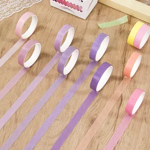 Colorful minimalist washi tape rolls set displayed on wooden background for DIY craft