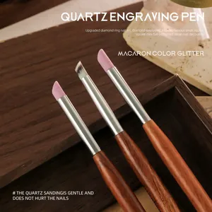 Professional quartz engraving nail pens with wood handles and pink sanding tips.