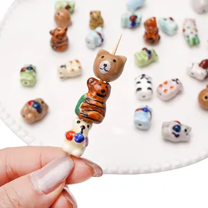 Hand-painted colorful ceramic animal beads for DIY jewelry making and phone chain decor.