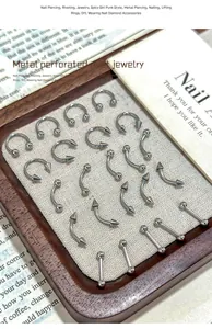 Diverse 304 stainless steel nail piercing jewelry set in various shapes and styles.