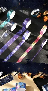 Detailed macro view of galaxy-themed washi tapes featuring elegant gold foil stamping.