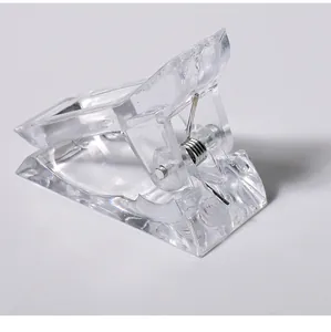 Detail view of a clear plastic nail extension clip with a durable metal spring.