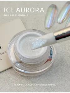 Macro view of white aurora chrome nail powder in a mesh jar with applicator brush
