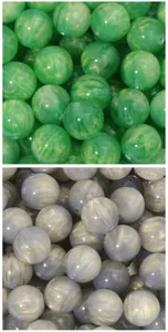 Close-up of marbled resin beads with golden sand cat eye effect for DIY jewelry