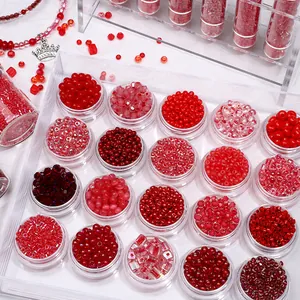 Macro view of assorted red glass seed beads organized in clear round storage containers
