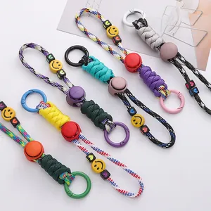 Close-up detail of colorful paracord keychains featuring smiley face and heart beads