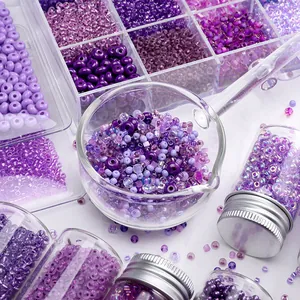 Macro view of assorted purple glass seed beads in clear containers for DIY jewelry