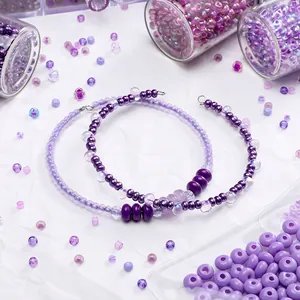 Macro view of assorted purple glass beads and finished handmade beaded bracelets