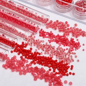 Close-up of vibrant red glass seed beads spilling from glass tubes for DIY jewelry