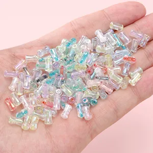 Macro detail of 4x8mm iridescent iridescent bamboo-shaped glass beads for jewelry making.