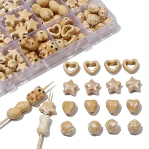 Detailed view of various beige ceramic beads in heart star and floral shapes for DIY craft