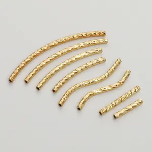 Macro view of diamond-cut gold-filled curved and straight tubes for DIY jewelry making