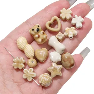 Macro view showing a collection of various shaped ceramic beads in earthy tones for DIY jewelry