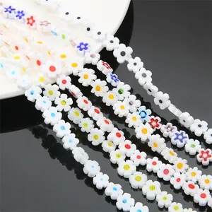 Close-up detail of white millefiori flower beads with colorful centers for jewelry DIY