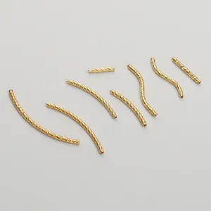 Detail of 14K gold filled textured spacer tubes in curved and straight shapes for DIY