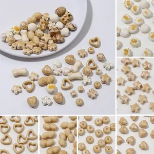Assorted cream and beige ceramic beads in heart and star shapes for DIY jewelry making crafts