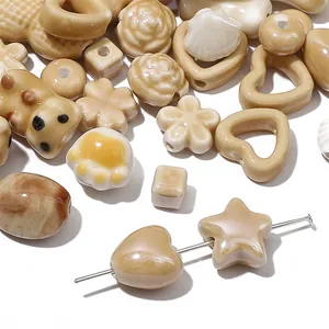 Variety of glazed ceramic beads in heart star flower shapes for DIY jewelry jewelry making