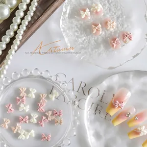 Exquisite creamy pink resin bow nail art accessories for elegant DIY manicure decoration