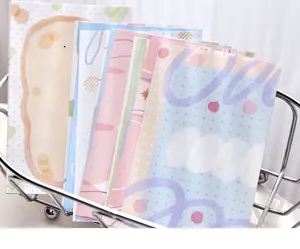 Close-up of pastel colored decorative memo papers stacked neatly in a silver wire basket