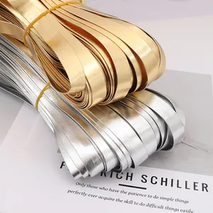 Close-up of shiny gold and silver PU leather binding strips for DIY sewing projects