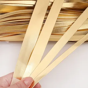 Macro detail view of shiny gold PU leather binding strips for DIY craft projects