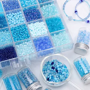 Close-up of assorted blue glass beads for DIY jewelry making in storage containers.