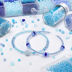 Macro view of assorted blue DIY glass seed beads and round beads for jewelry making
