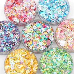 Set of seven jars with assorted colorful iridescent sequins for DIY craft decoration.