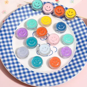 Detailed macro view of 20mm colorful acrylic smiley face charms for DIY jewelry.