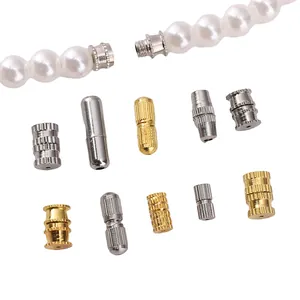 Close-up view of various metal screw clasps and barrel connectors for DIY jewelry