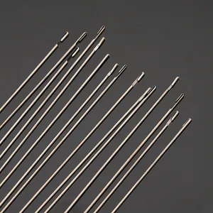 Macro close-up view showing the precise hook tips of stainless steel beading needles