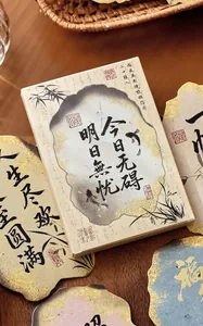 Close-up of Chinese style boxed postcards with elegant calligraphy and burnt edge design