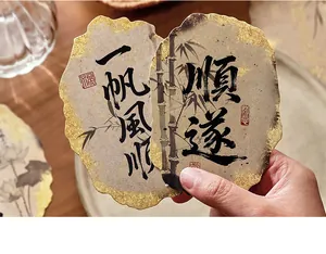 Detailed view of vintage Chinese calligraphy postcards with elegant gold foil edges