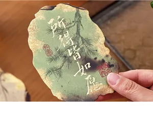 Close-up of vintage style postcard with pine tree and Chinese calligraphy