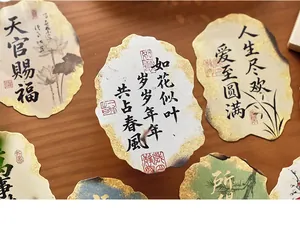 Macro view of vintage Chinese calligraphy postcards with gold foil and irregular burnt edges