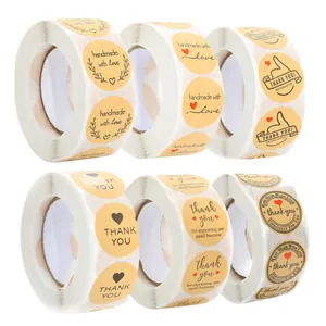 Detail view of round kraft paper sticker rolls with various handmade and thank you designs