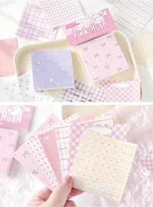 Close-up of pastel patterned memo pads featuring heart, star, and bow designs for journaling