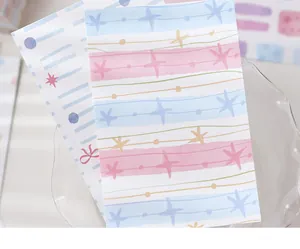 Close-up of pastel-colored striped journal paper featuring cute star and dot patterns