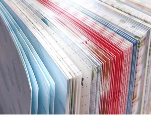 Detailed close-up of a thick stack of colorful patterned journaling papers