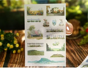 Detail view of vintage pastoral stickers featuring rabbits, fences, and scenic landscapes