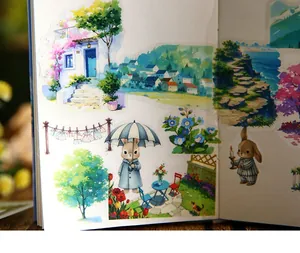 Detailed view of watercolor rabbit and landscape stickers applied to a journal page