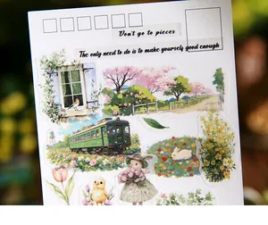 Close-up detail of retro scenery stickers featuring vintage trains, rabbits, and floral motifs.