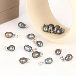 Close-up detail of 7-8mm iridescent black rice pearl pendants with S925 silver bails for jewelry.