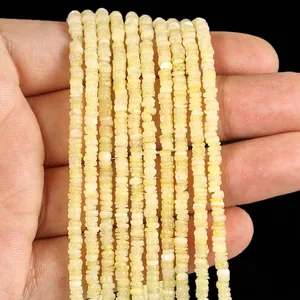 Close-up view of natural 3mm white shell disc beads for DIY jewelry making accessories.