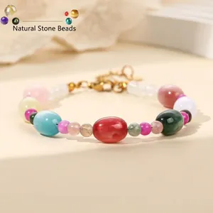 Detail view of colorful gemstone bead bracelet with mixed round and oval stones