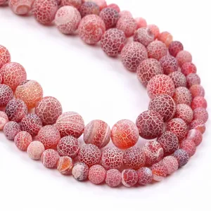 Detailed view of red weathered stone beads with unique white dragon vein patterns