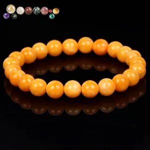 High-quality orange natural stone beaded bracelet with glossy finish on black background.